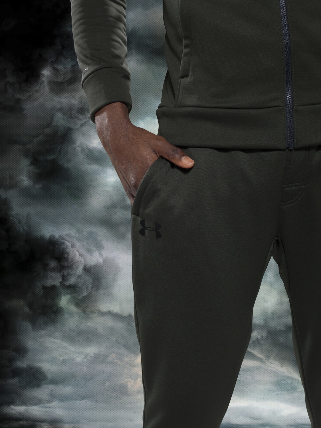 olive green under armour tracksuit on a stormy background