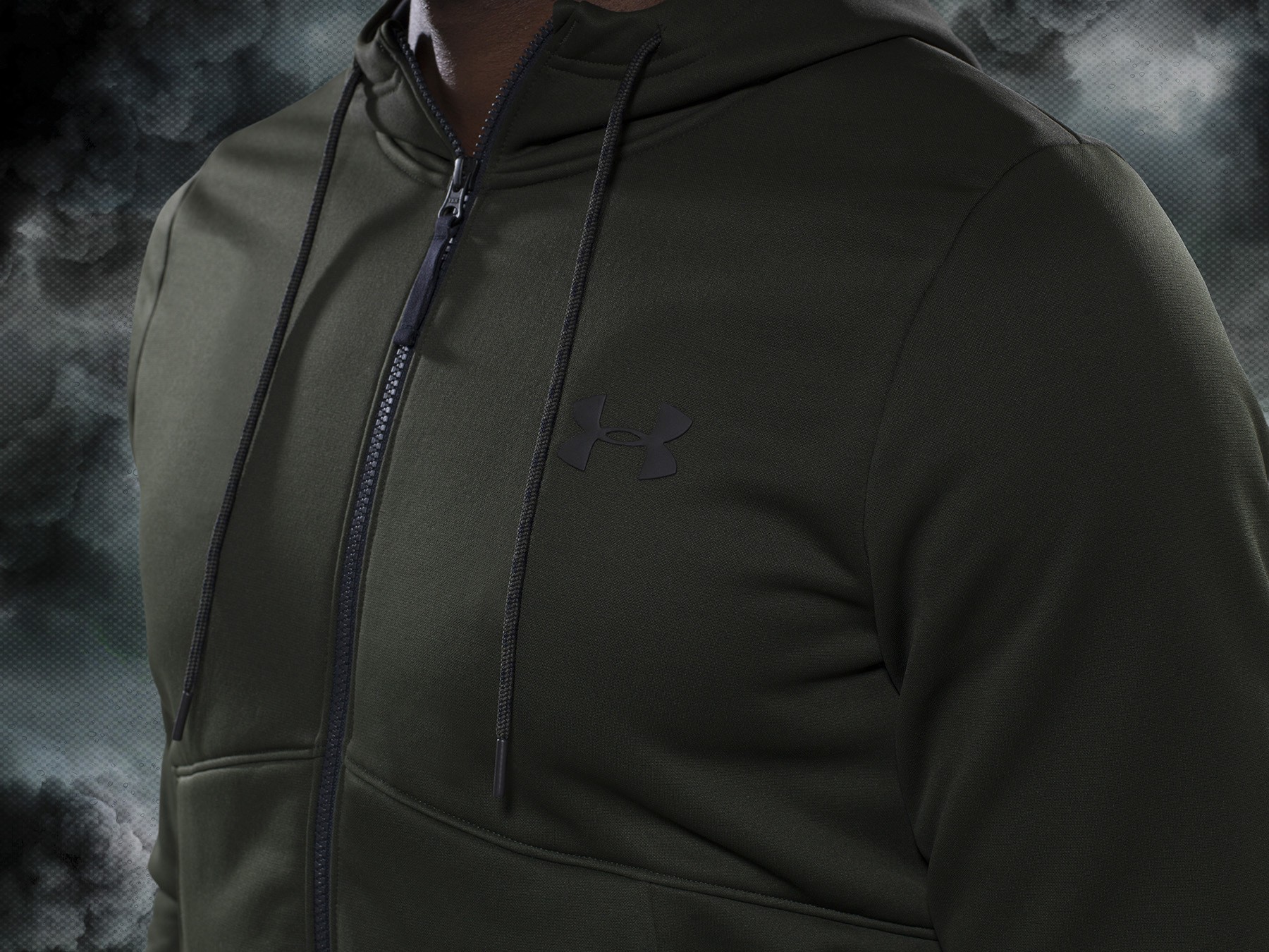 olive green under armour track top on a stormy background